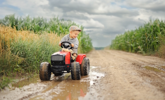 a child on a toy tractor