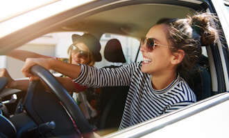 two women smiling in a car